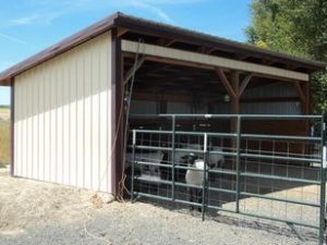 Wooden animal barn with fence and gate